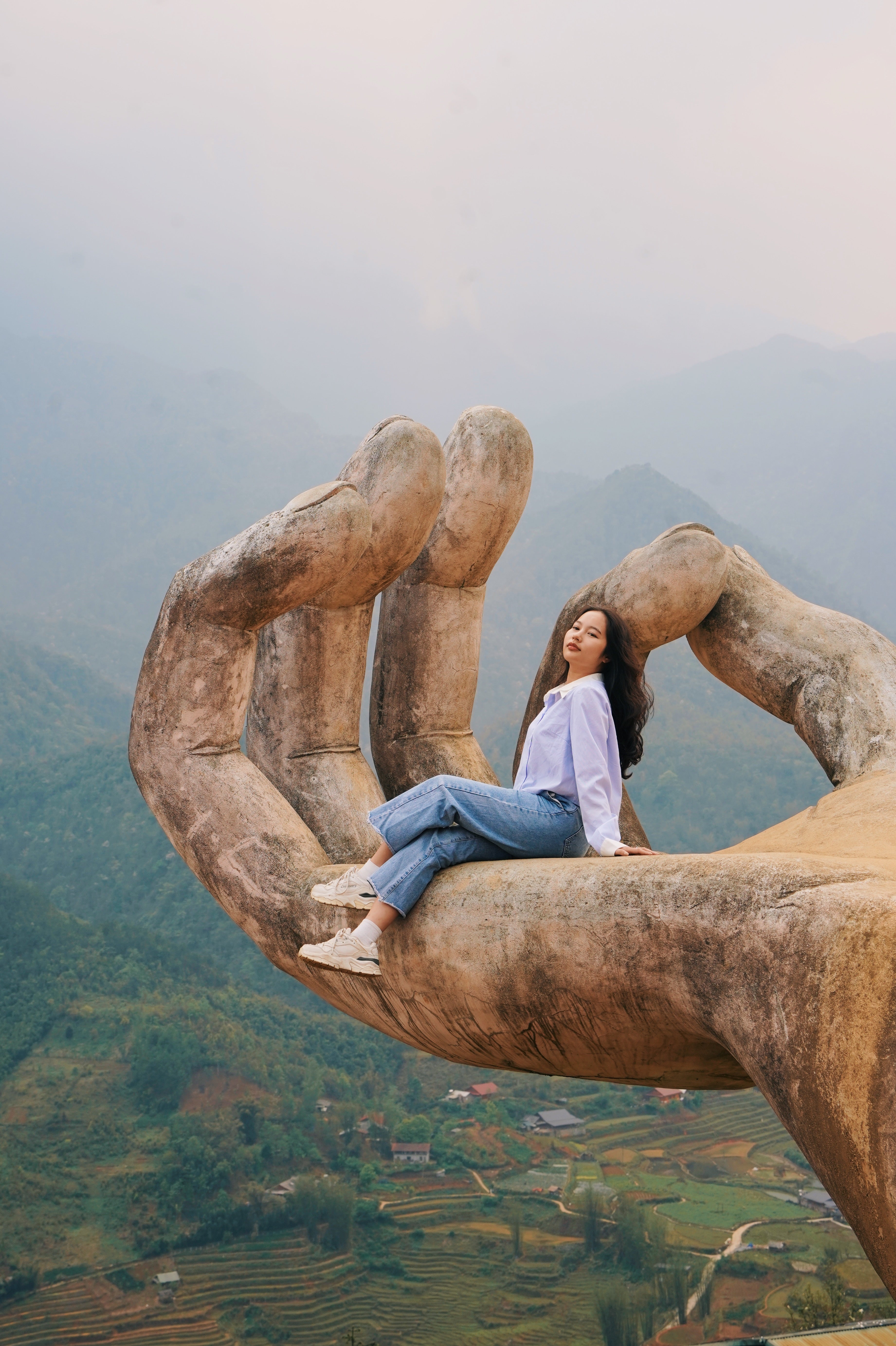 North_Vietnam_Sapa_Thao_Sitting_on_Large_Hand.jpg